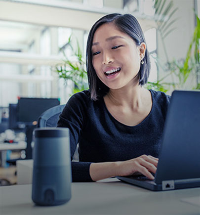 Woman speaking to voice activated device